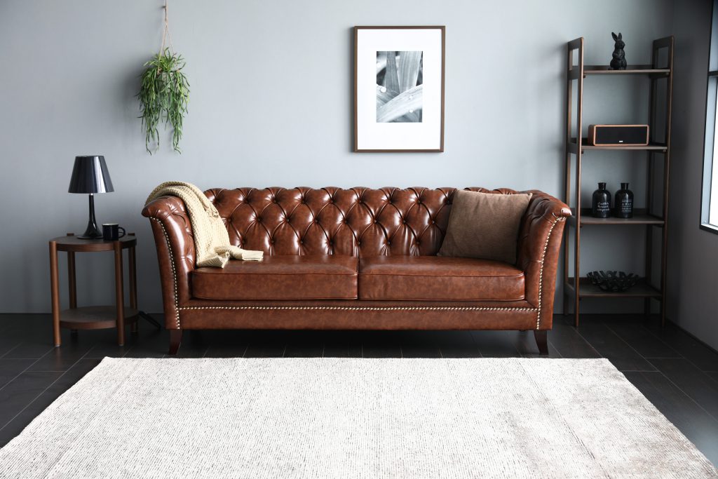 Neil Chesterfield Sofa in PU Leather in a living room.