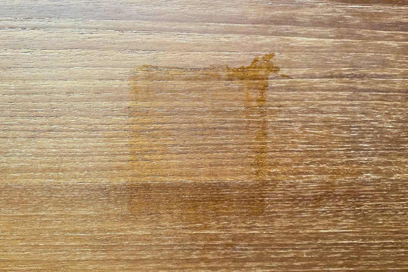Heat stained wooden surface from hot baking pan. Maintain wood furniture: clean heat stains.